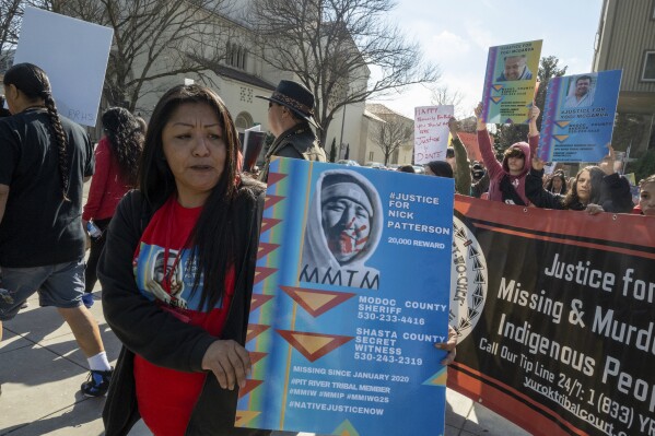 Lynette Craig marches with a poster of her brother who went missing in 2020 around the California State Capitol at the second annual Missing and Murdered Indigenous People Summit and Day of Action on Tuesday, Feb. 13, 2024, in Sacramento, Calif. (APPhoto/Jose Luis Villegas)