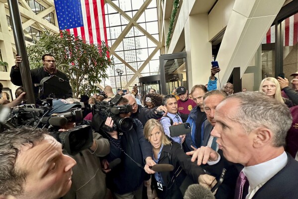 Minnesota State Trooper Ryan Londregan's attorney Chris Madel is drowned out by protesters after a hearing for his client at the Hennepin County Government Center on Monday, April 29, 2024, in Minneapolis, Minn. Longdregan is charged with killing Ricky Cobb II during a during a traffic stop in the summer of 2023. (AP Photo/Mark Vancleace)
