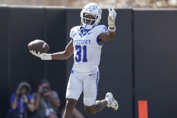 Kentucky defensive back Maxwell Hairston (31) celebrates after returning an interception for a touchdown against Vanderbilt in the second half of an NCAA college football game, Saturday, Sept. 23, 2023, in Nashville, Tenn. (AP Photo/George Walker IV)
