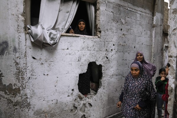 Palestinians inspect the site of an Israeli strike after a military raid in the town of Tulkarem, West Bank, Wednesday, Nov. 22, 2023. The Palestinian Health Ministry said the Israeli military killed six Palestinians, five of them militants, during a raid that sparked an hourslong firefight with militants in a flashpoint refugee camp in the northern city of Tulkarem. (AP Photo/Majdi Mohammed)