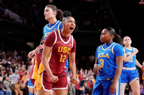 Southern California guard JuJu Watkins (12) celebrates after scoring as UCLA center Lauren Betts (51) and guard Londynn Jones (3) look on during the second half of an NCAA college basketball game, Thursday, Feb. 13, 2025, in Los Angeles. (AP Photo/Mark J. Terrill, File)