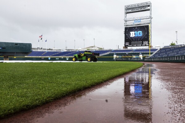Rainy weather delays an NCAA college Big Ten conference tournament baseball game between Indiana and Purdue Tuesday, May 21, 2024, in Omaha Neb. (Chris Machian/Omaha World-Herald via AP)