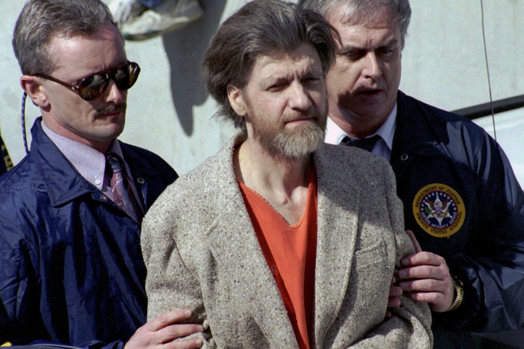 FILE - Theodore "Ted" Kaczynski is flanked by federal agents as he is led to a car from the federal courthouse in Helena, Mont., April 4, 1996. (AP Photo/John Youngbear, File)
