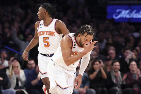 New York Knicks guard Jalen Brunson gestures after making a three point shot against the Brooklyn Nets as New York Knicks guard Immanuel Quickley (5) watches during the first half of an NBA basketball game, Monday, Feb. 13, 2023, in New York. (AP Photo/Jessie Alcheh)
