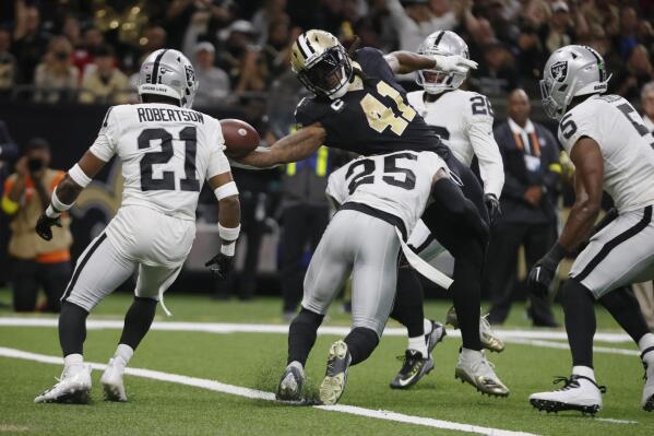 New Orleans Saints running back Alvin Kamara (41) stretches across the goal line for a touchdown against Las Vegas Raiders safety Tre'von Moehrig (25) during the first half of an NFL football game Sunday, Oct. 30, 2022, in New Orleans. (AP Photo/Butch Dill)