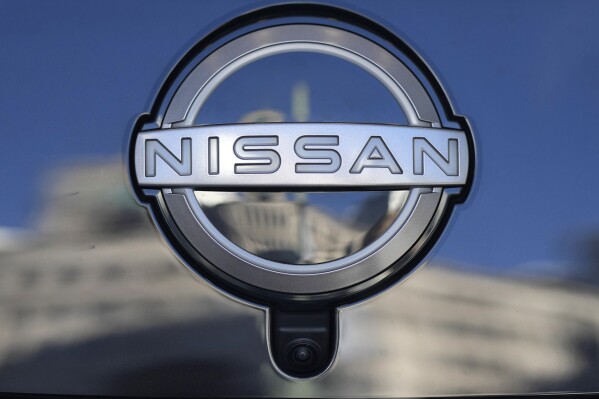 FILE - A Nissan logo is seen on a car at its showroom in Tokyo on Feb. 21, 2023. Nissan’s profit zoomed up more than 10-fold in July-September from a year earlier, boosted by a weak Japanese yen and strong vehicle sales around the world. (AP Photo/Shuji Kajiyama, File)
