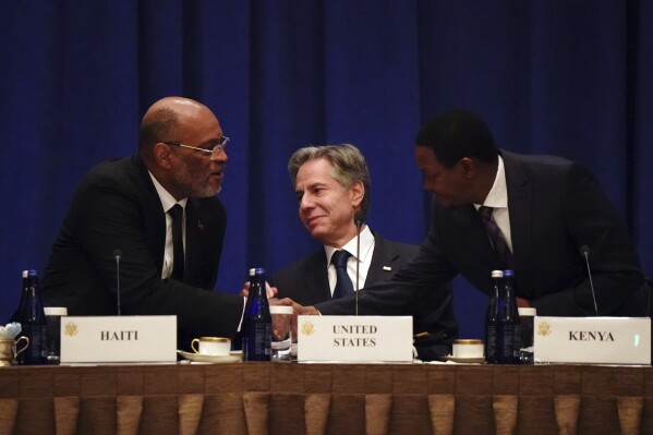 Prime Minister of Haiti Ariel Henry, left, greets Kenyan Cabinet Secretary for Foreign and Diaspora Affairs Alfred Nganga Mutua, right, before United States Secretary of State Antony Blinken addresses diplomats during a meeting on the security situation in Haiti in New York on Friday, Sept. 22, 2023. (Bing Guan/Pool Photo via AP)