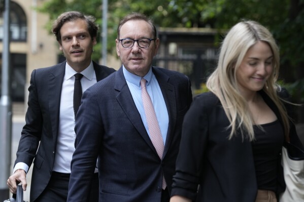 Actor Kevin Spacey, centre, arrives at Southwark Crown Court for the start of his trial in London, Wednesday, June 28, 2023. Spacey is going on trial on charges he sexually assaulted four men as long as two decades ago. The double-Oscar winner faces a dozen charges as his trial begins Wednesday at Southwark Crown Court. (AP Photo/Frank Augstein)