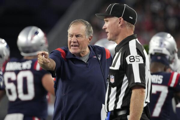New England Patriots head coach Bill Belichick, left, speaks with line judge Daniel Gallagher (85) during the first half of the team's preseason NFL football game against the Carolina Panthers, Friday, Aug. 19, 2022, in Foxborough, Mass. (AP Photo/Michael Dwyer)