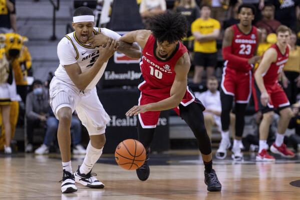 Georgia's Aaron Cook, right, steals the ball from Jarron Coleman, left, during the first half of an NCAA college basketball game Saturday, March 5, 2022, in Columbia, Mo. (AP Photo/L.G. Patterson)