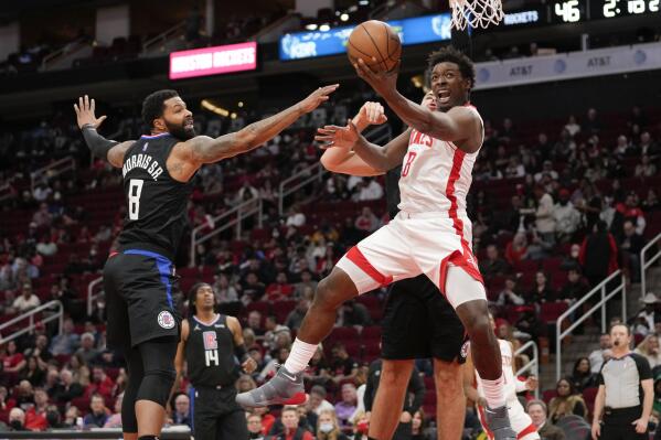 Houston Rockets forward Jae'Sean Tate, front right, shoots as Los Angeles Clippers forward Marcus Morris Sr., left, defends during the first half of an NBA basketball game, Sunday, Feb. 27, 2022, in Houston. (AP Photo/Eric Christian Smith)