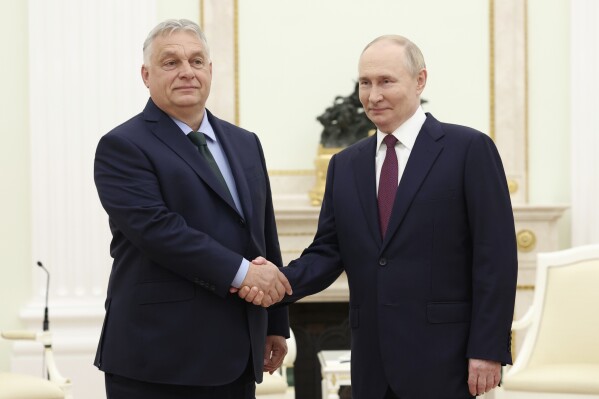 Russian President Vladimir Putin, right, and Hungarian Prime Minister Viktor Orban shake hands during a meeting in Moscow, July 5, 2024. (Valeriy Sharifulin, Sputnik, Kremlin Pool Photo via AP)