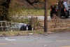 A St. Louis County medical examiner documents the scene where a motorist was struck and killed by a suspect fleeing police in a vehicle on W. Florissant Ave., Wednesday, Nov. 22, 2023 in Ferguson, Mo., at the Dellwood border. (Christian Gooden/St. Louis Post-Dispatch via AP)