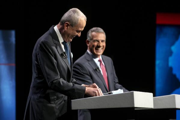Incumbent Gov. Phil Murphy, D-N.J., left, and Republican challenger Jack Ciattarelli laugh on stage during a gubernatorial debate at New Jersey Performing Arts Center, Tuesday, Sept. 28, 2021, in Newark, N.J. (Amy Newman/The Record via AP)