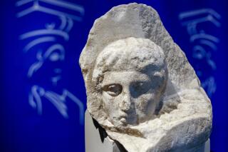 FILE - The marble head of a young man, a tiny fragment from the 2,500-year-old sculptured decoration of the Parthenon Temple on the ancient Acropolis, is displayed during a presentation to the press at the new Acropolis Museum in Athens, Nov. 5, 2008. The Vatican and Greece were finalizing a deal Tuesday March 7, 2023 to return three fragments of the Parthenon Marbles that have been in the collection of the Vatican Museums for two centuries. (AP Photo/Thanassis Stavrakis, File)