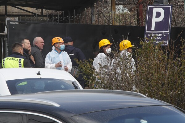 Police officers investigate a nightclub after a massive fire in the town of Kocani, North Macedonia, Sunday, March 16, 2025. (AP Photo/Boris Grdanoski)