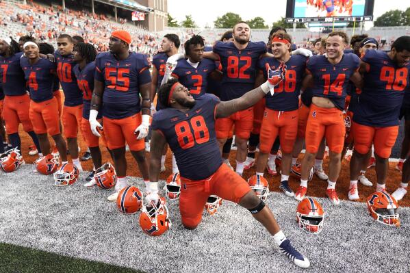Illinois defensive lineman Keith Randolph Jr., leads his teammates in singing the school's alma mater after an NCAA college football game against Virginia, Saturday, Sept. 10, 2022, in Champaign, Ill. Illinois won 24-3. (AP Photo/Charles Rex Arbogast)