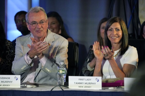 FILE - New Jersey Gov. Phil Murphy, left, and first lady Tammy Murphy attend the National Governors Association summer meeting, July 15, 2022, in Portland, Maine. Murphy, who is running for U.S. Senate, said Tuesday she opposes construction of a gas-fired backup power plant in a minority neighborhood already heavily burdened with pollution. But she did not say whether she has discussed her view with the one person who could stop the project in its tracks 鈥� her husband, Gov. Phil Murphy. (APPhoto/Robert F. Bukaty, File)