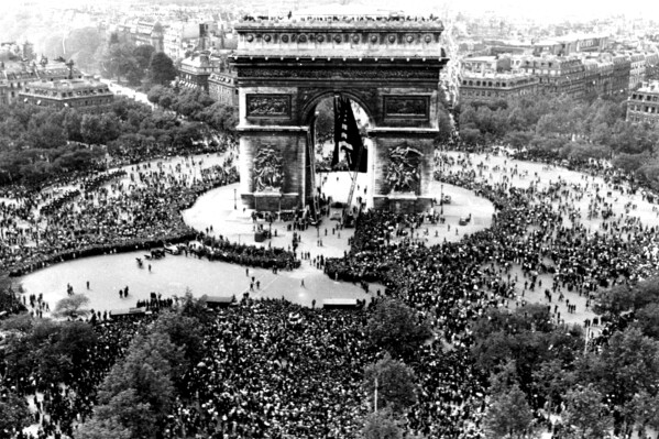 Thousands celebrate the announcement of Germany's unconditional surrender to the Allies in World War II, on May 7, 1945, at the Arc de Triomphe in Paris on VE Day. (AP Photo/File)