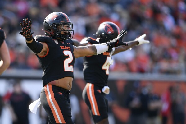 Oregon State linebacker Calvin Hart Jr. (2) and defensive back Jaden Robinson (4) celebrate a missed field goal during the second half of an NCAA college football game against San Diego State, Saturday, Sept. 16, 2023, in Corvallis, Ore. (AP Photo/Mark Ylen)
