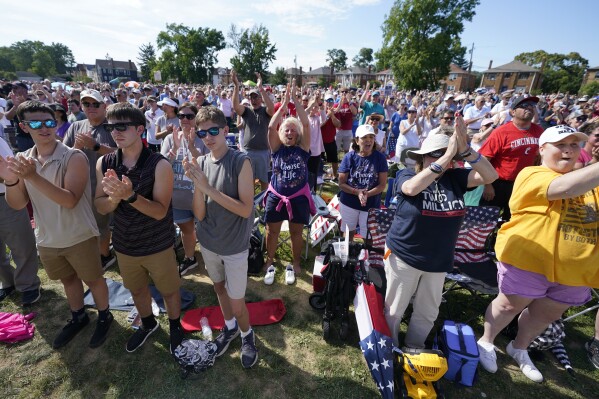 A crowd cheers as Jim Caviezel speaks during a 