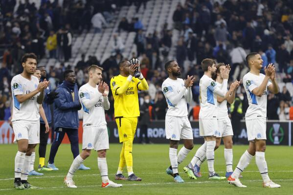 Marseille's players celebrate with supporters after winning the Europa Conference League round of 16 soccer match between Marseille and FC Basel in Marseille, France, Thursday, March 10, 2022. (AP Photo/Jean-Francois Badias)