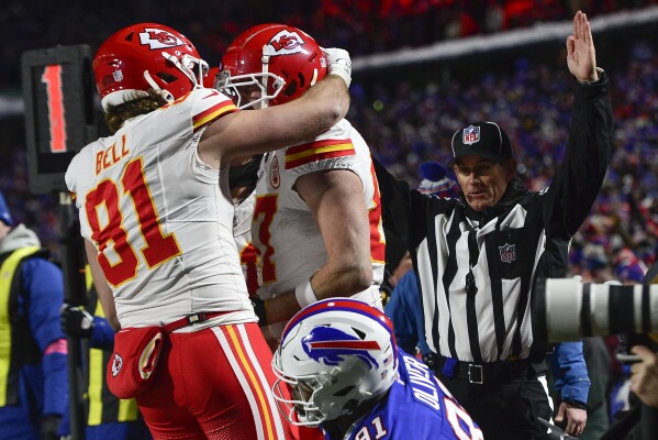 Kansas City Chiefs tight end Travis Kelce (87) celebrates with tight end Blake Bell (81) after scoring a touchdown against the Buffalo Bills during the third quarter of an NFL AFC division playoff football game, Sunday, Jan. 21, 2024, in Orchard Park, N.Y. (AP Photo/Adrian Kraus)