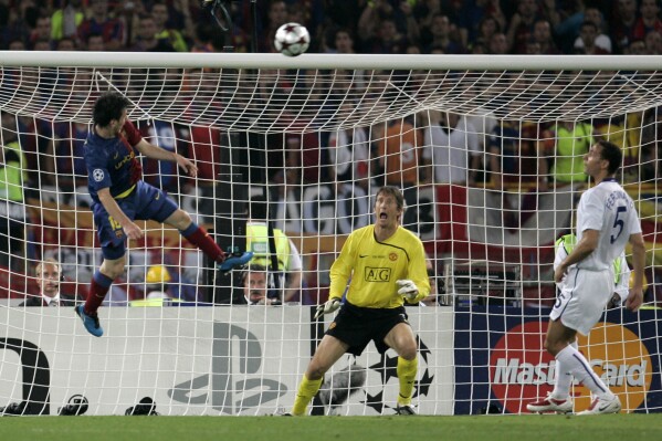 Barcelona's Lionel Messi, left, scores on a header during the UEFA Champions League final soccer match between Manchester United and Barcelona in Rome, May 27, 2009. (AP Photo/Gregorio Borgia, File)