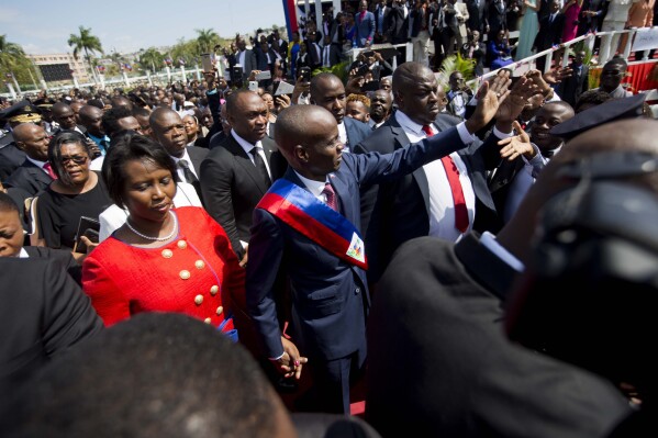 FILE - Haiti's President Jovenel Moise walks with his wife Martine to the National Palace after being sworn-in, in Port-au-Prince, Haiti Feb. 7, 2017. Attorneys for the widow of the slain president filed a lawsuit on June 22, 2023 in Florida against those accused in his assassination, which is still under investigation. (AP Photo/Dieu Nalio Chery, File)