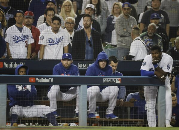 
              Los Angeles Dodgers' Yasiel Puig, right, and his teammates watches the eighth inning in Game 5 of the World Series baseball game against the Boston Red Sox on Sunday, Oct. 28, 2018, in Los Angeles. (AP Photo/David J. Phillip)
            