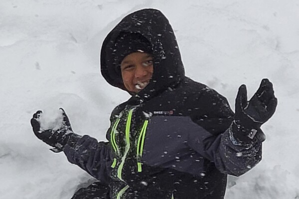 Ahmir Jolliff, who was killed in a school shooting on Thursday, Jan. 4, 2024, in Perry, Iowa, plays in the snow in this undated photo. He was 11 years old and a sixth grader when he died. Authorities say a 17-year-old opened fire in the cafeteria of Perry High School before classes began for the day, killing Ahmir and wounding seven other people. The teenage suspect died of a self-inflicted gunshot wound. (Erica Jolliff via AP))