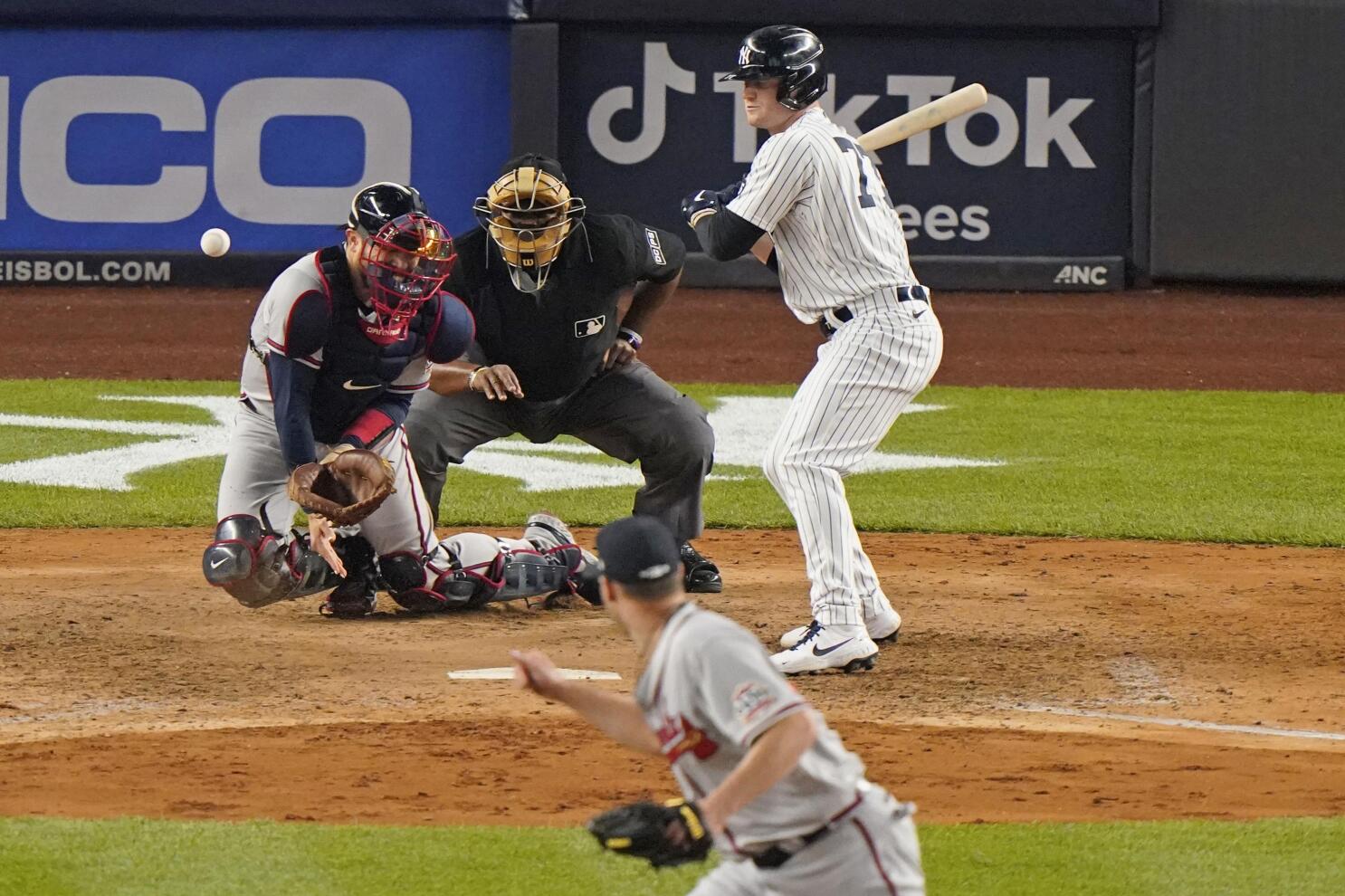 MLB umpire Laz Diaz looks to throw a baseball into the stands