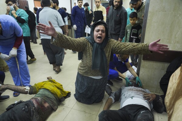 Palestinians injured in Israeli bombing on the Gaza Strip are brought to a hospital in Deir al-Balah, Sunday, Dec. 3, 2023.  (AP Photo/ Hatem Moussa)