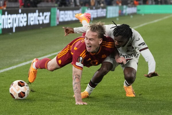 Roma's Rick Karsdorp (left) accepts a challenge from Leverkusen's Jeremy Frimpong during the Europa League semi-final first leg match between Roma and Bayer Leverkusen at the Olympic Stadium in Rome, Italy on Thursday, May 2, 2024.  (AP Photo/Andrew Medichini)