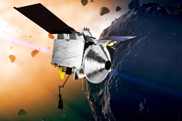 FILE - This illustration provided by NASA depicts the OSIRIS-REx spacecraft at the asteroid Bennu. On Monday, May 10, 2021, the robotic explorer fired its engines, headed back to Earth with samples it collected from the asteroid, nearly 200 million miles away. (Conceptual Image Lab/Goddard Space Flight Center/NASA via AP)