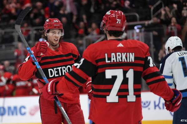 Detroit Red Wings center Dylan Larkin (71) celebrates his goal with Moritz Seider (53) in the second period of an NHL hockey game against the Winnipeg Jets Tuesday, Jan. 10, 2023, in Detroit. (AP Photo/Paul Sancya)