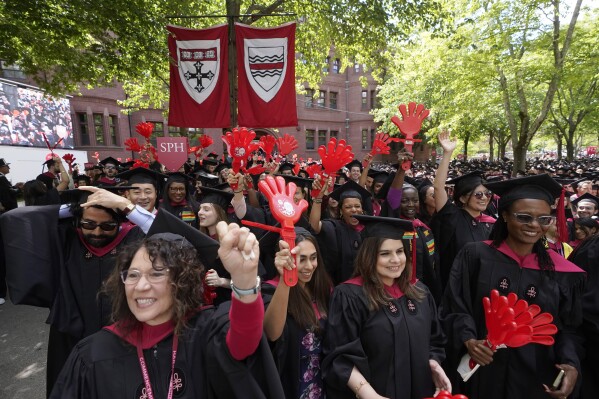 File - Graduating Harvard University students celebrate their degrees during commencement ceremonies, on May 25, 2023 in Cambridge, Mass. Student loan payments resume in October after a three-year pause due to the pandemic. (AP Photo/Steven Senne, File. )