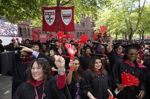 File - Graduating Harvard University students celebrate their degrees during commencement ceremonies, on May 25, 2023 in Cambridge, Mass. Student loan payments resume in October after a three-year pause due to the pandemic. (Ǻ Photo/Steven Senne, File. )