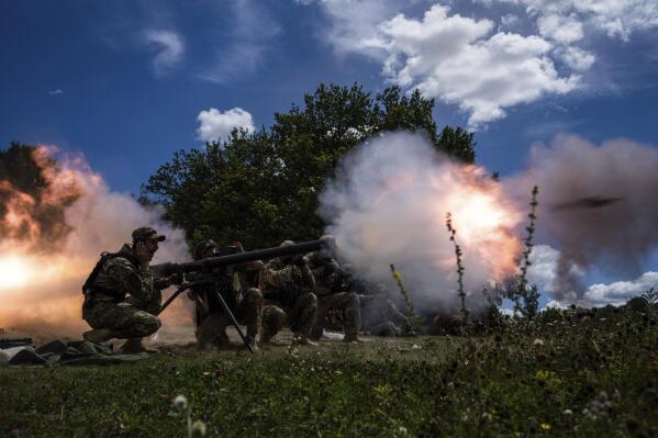 Ukrainian servicemen shoot with SPG-9 recoilless gun during training in Kharkiv region, Ukraine, Tuesday, July 19, 2022. (AP Photo/Evgeniy Maloletka)