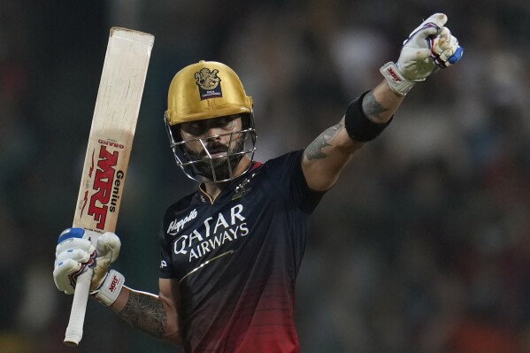 FILE - Royal Challengers Bangalore's Virat Kohli celebrates his century during the Indian Premier League cricket match between Royal Challengers Bangalore and Gujarat Titans in Bengaluru, India, on May 21, 2023. The Indian Premier League’s season begins in Chennai on Friday March 22, 2024 when defending champions Chennai Super Kings take on fan favorites Royal Challengers Bengaluru. It will be a star-studded opening fixture of the ten-team tournament with MS Dhoni leading Chennai against and Virat Kohli and Bengaluru. (AP Photo /Aijaz Rahi, File)