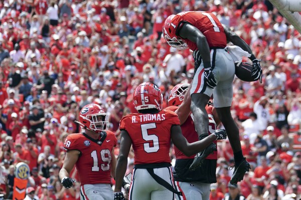 Georgia wide receiver Marcus Rosemy-Jacksaint (1) celebrates with offensive lineman Tate Ratledge (69) and Brock Bowers (19) after scoring aa touchdown in the first half of an NCAA college football game against the Ball State Saturday, Sept. 9, 2023, in Athens, Ga. (AP Photo/John Bazemore)