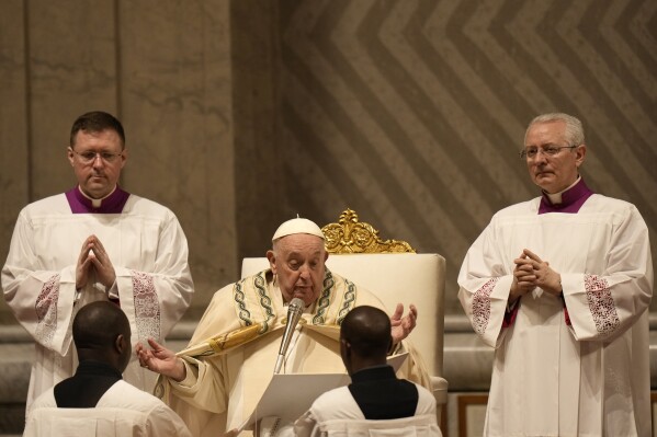 Pope Francis presides over the Easter vigil celebration in St. Peter's Basilica at the Vatican, Saturday, March 30, 2024. (AP Photo/Alessandra Tarantino)