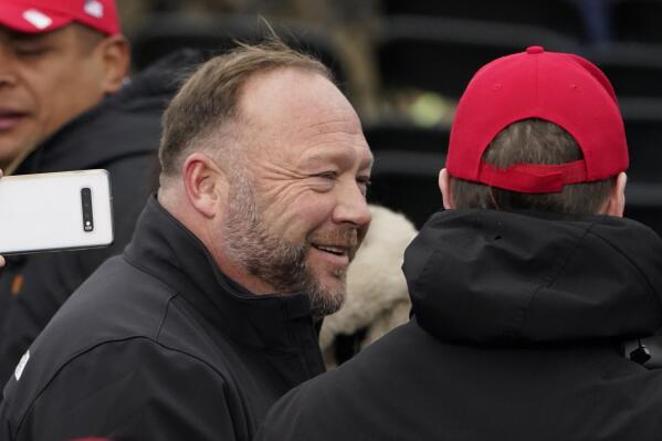 FILE - Alex Jones, left, attends a rally in support of President Donald Trump called the "Save America Rally," Wednesday, Jan. 6, 2021, in Washington. The wife of the conspiracy theorist was arrested Friday, Dec. 24, 2021, Christmas Eve on a domestic violence charge that the right-wing provocateur said stems from a “medication imbalance.” (AP Photo/Jacquelyn Martin, File)