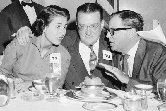 FILE - Councilwoman Rosalind Wyman, left, Walter OMalley, Los Angeles Dodger owner, and Los Angeles Mayor Norris Poulson, right, talk at a luncheon at the Statler Hotel, where over a 1000 guests and city officials greeted the Dodger ballplayers, Nov. 1, 1957, in Los Angeles. Wyman, a pioneering woman in Los Angeles city government who was instrumental in bringing the Dodgers to town and a longtime insider in California Democratic politics, has died, her family said Thursday, Oct. 27, 2022. She was 92. (AP Photo/Don Brinn, File)