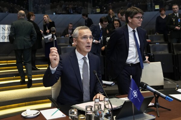 NATO Secretary General Jens Stoltenberg bangs a gavel to signify the start of a meeting of the North Atlantic Council in defense ministers session at NATO headquarters in Brussels, Thursday, Feb. 15, 2024. (AP Photo/Virginia Mayo)