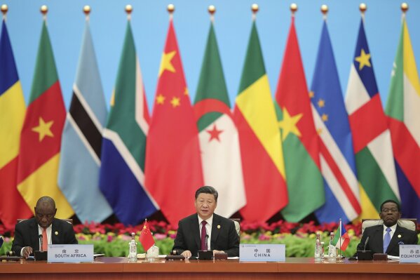 FILE - In this Sept. 4, 2018, file photo, Chinese President Xi Jinping speaks with South African President Cyril Ramaphosa, left, during the 2018 Beijing Summit of the Forum on China-Africa Cooperation - Round Table Conference at the Great Hall of the People in Beijing. China's loans to poor countries in Africa and Asia impose unusual secrecy and repayment terms that are hurting their ability to renegotiate debts after the coronavirus pandemic, a group of U.S. and German researchers said in a report Wednesday, March 31, 2021. (Lintao Zhang/Pool photo via AP, File)