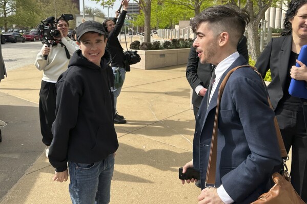 ACLU attorney Chase Strangio, right, and actor Elliot Page leave the 8th U.S. Circuit Court of Appeals after a hearing Thursday, April 11, 2024, in St. Louis. The Federal appeals court is hearing arguments over Arkansas' first-in-the-nation ban on gender-affirming care for minors. Page was at the hearing in support of the ACLU’s challenge to the law. (AP Photo/Jim Salter)