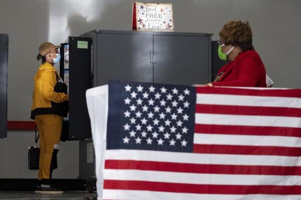 A voter marks her ballot during the first day of early voting in Atlanta on Monday, Oct. 17, 2022. (AP Photo/Ben Gray)