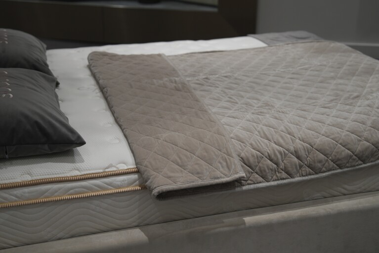 Weighted blankets on display in a Saatva mattress showroom in New York, Dec. 4, 2024. (AP Photo/Mary Conlon)
