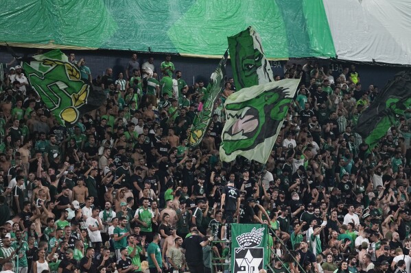 Maccabi fans cheer before a UEFA Europe League match between Panathinaikos and Maccabi Haifa in Haifa, Israel, Thursday, Oct. 5, 2023. (AP Photo/Ohad Zwigenberg)